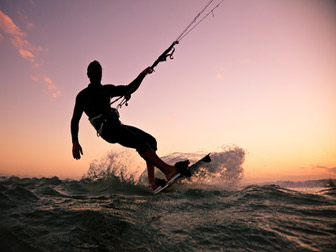 Faire du kite au coucher du soleil